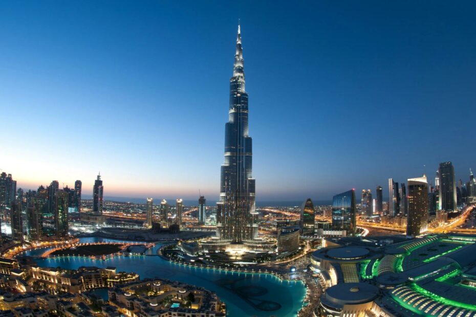 The iconic Dubai skyline during sunset. The Burj Khalifa, the tallest building in the world, stands prominently at the center. The sleek, tapering structure of the Burj Khalifa is illuminated by the setting sun. urrounding the Burj Khalifa are numerous other skyscrapers, each with unique architectural designs and varying heights. This view of the Dubai skyline is a mesmerizing and affordable activity, fitting perfectly with Dubai on a budget: 8 Epic things to do under R1000 and highlighting one of the cheap things to do in Dubai.