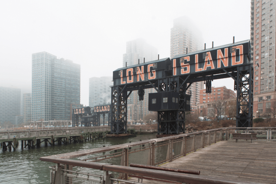 Misty view of Long Island sign with cityscape.
