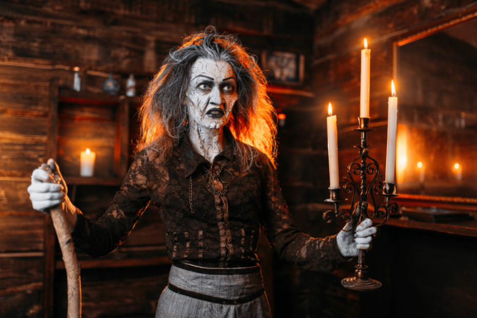 Scary witch with candlestick and cane reads spell